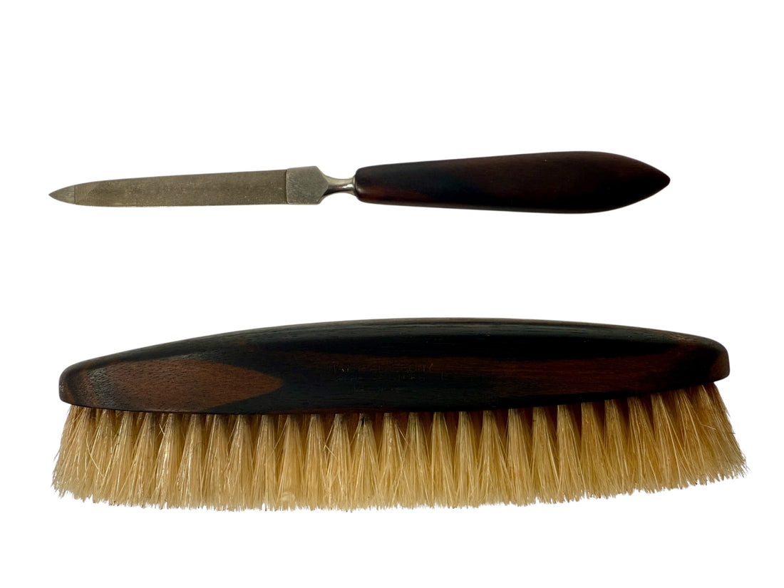 Two brushes with wooden handles and bristle heads on a white background