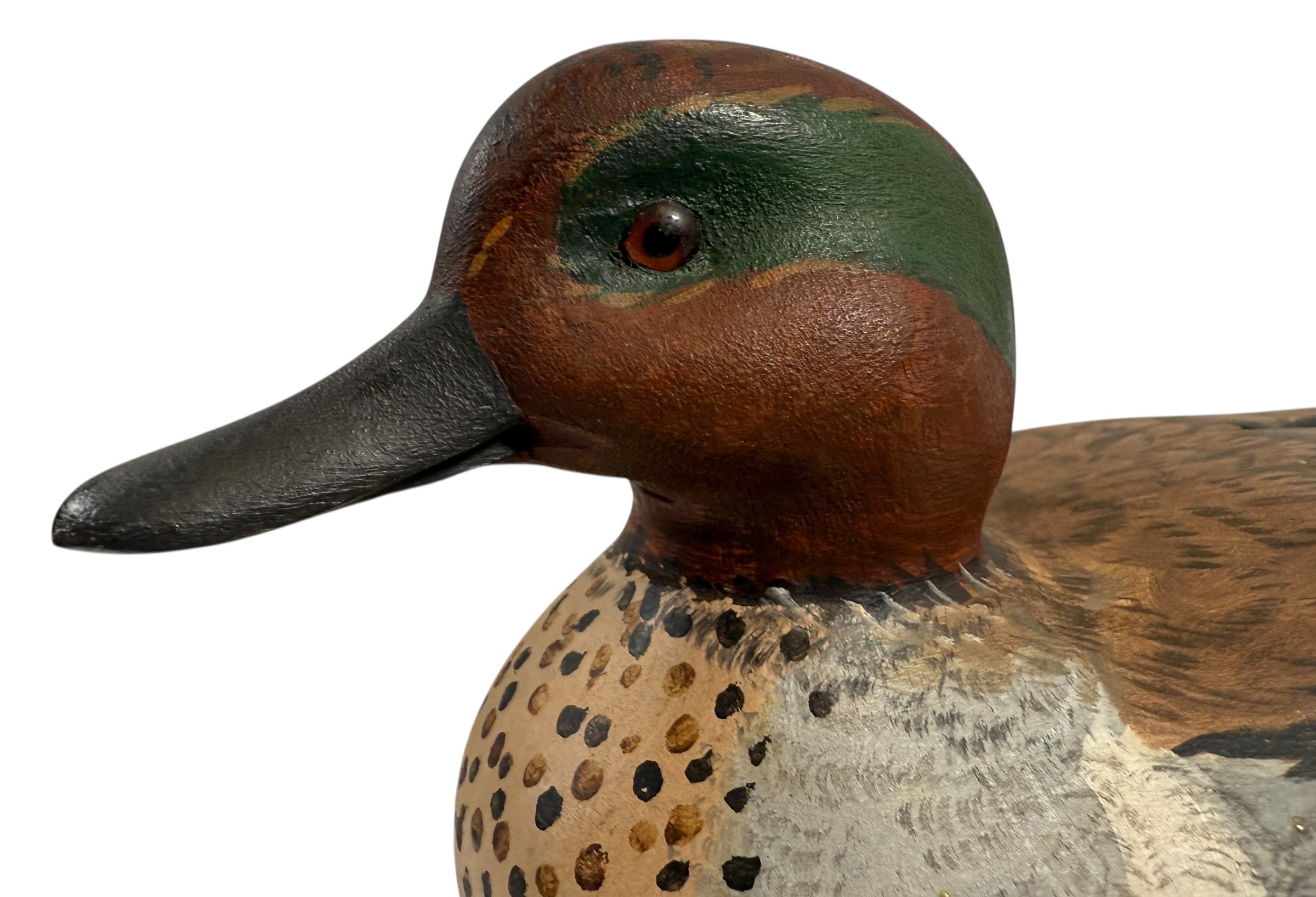 Close-up of a wooden duck decoy with detailed feathers and beak on a white background