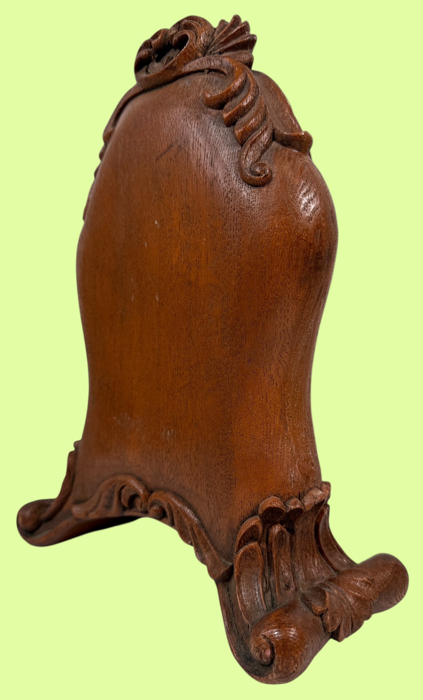 Decorative wooden object with intricate carvings on a white background