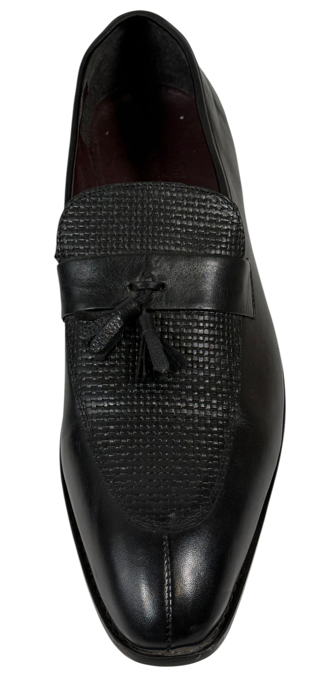 Black dress shoe with textured design on a white background
