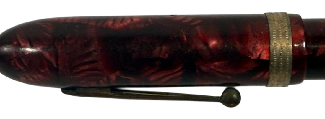 Penco Red and black pen with a textured surface on a white background