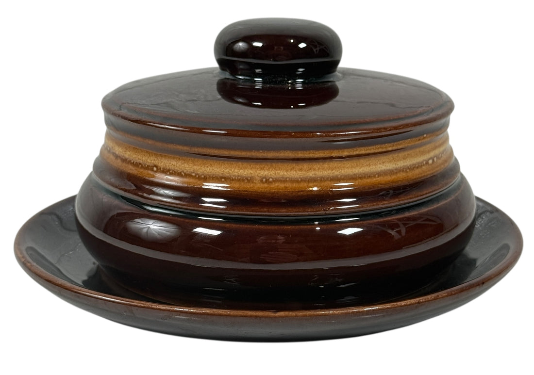 Brown ceramic dish with lid on a white background