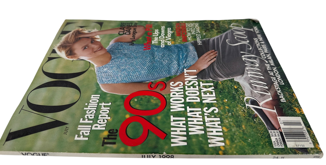 Vogue July 1998  magazine cover featuring a woman in a blue dress with text about fashion and lifestyle topics.