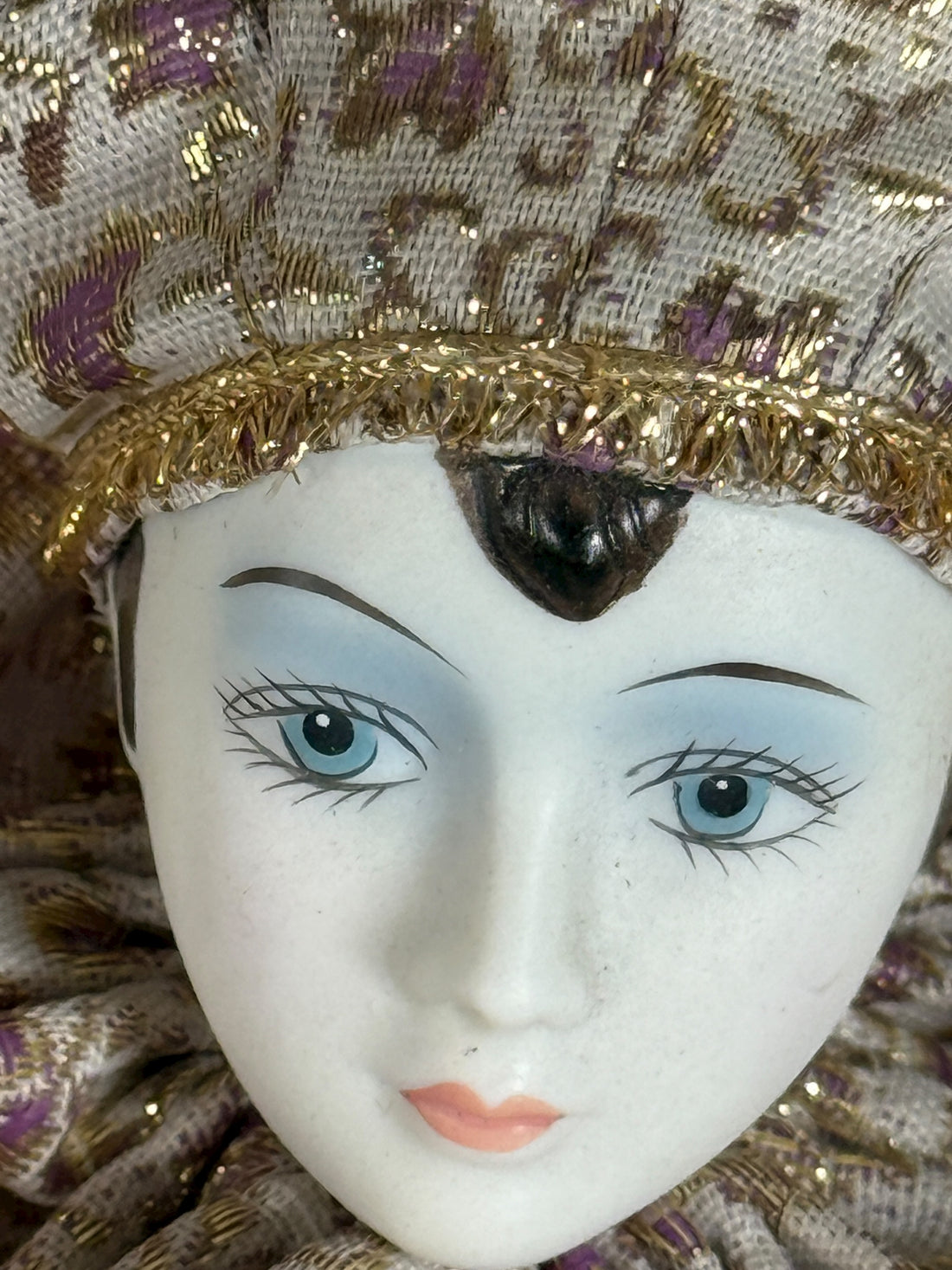 Vintage 18″ porcelain jester doll with mint satin and brocade costume. Elegant décor piece with porcelain head, hands, and feet.