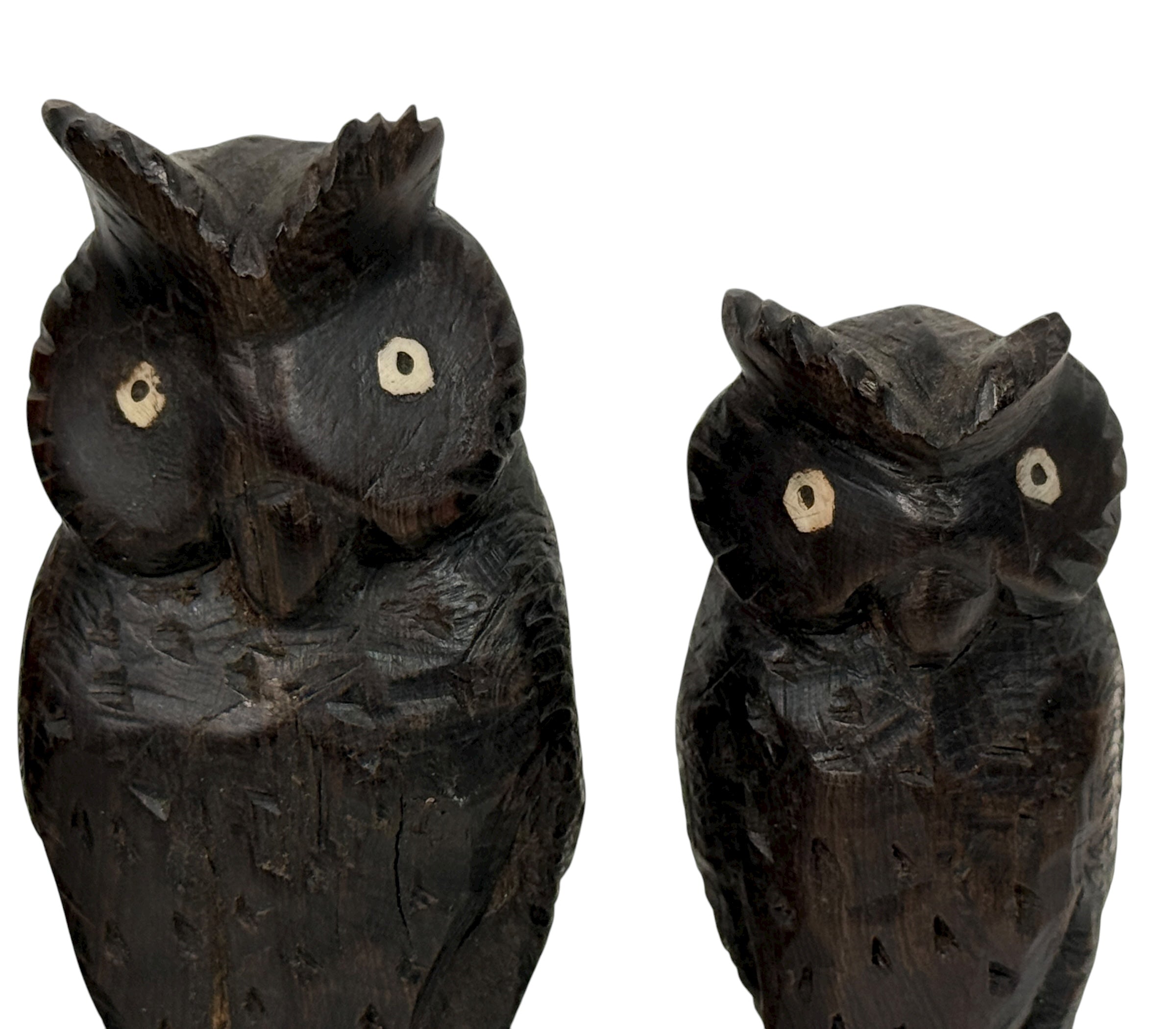 Two wooden owl figurines on a white background