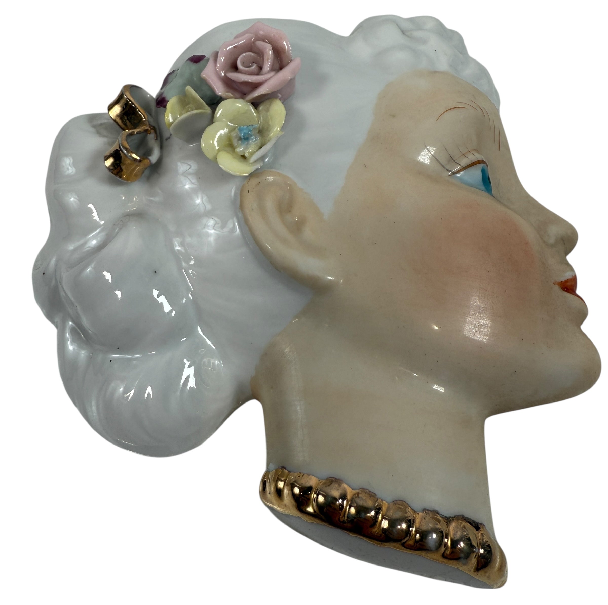 Mid-century Japanese porcelain lady-head wall mask with floral accents. Vintage décor piece with one chipped flower. Ideal for collectors and retro interiors.