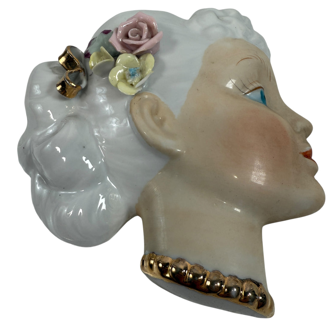 Mid-century Japanese porcelain lady-head wall mask with floral accents. Vintage décor piece with one chipped flower. Ideal for collectors and retro interiors.