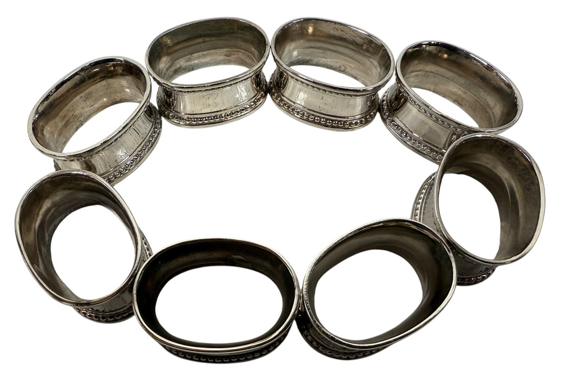Set of 8 classic silverplate napkin rings with beaded edges. Unmonogrammed, polished, and in very good condition. Timeless tableware.
