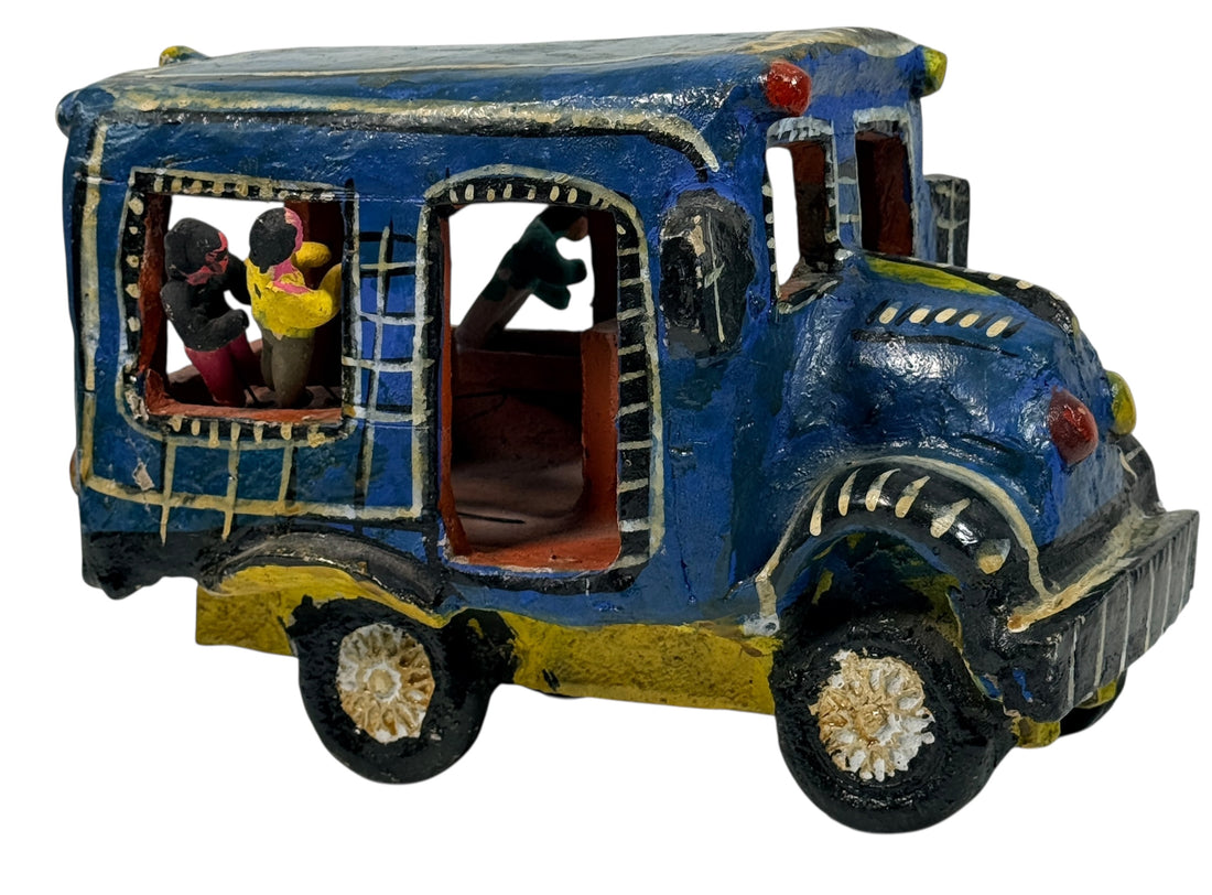 Vintage Mexican papier-mâché colectivo bus sculpture with hand-modeled interior figures. Folk art narrative piece with bold color and strong display presence.