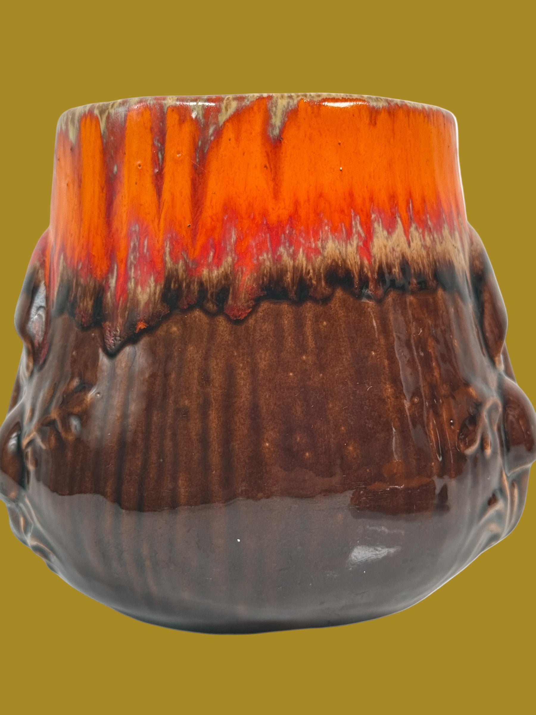 Ceramic vase with a gradient from orange to brown on a white background