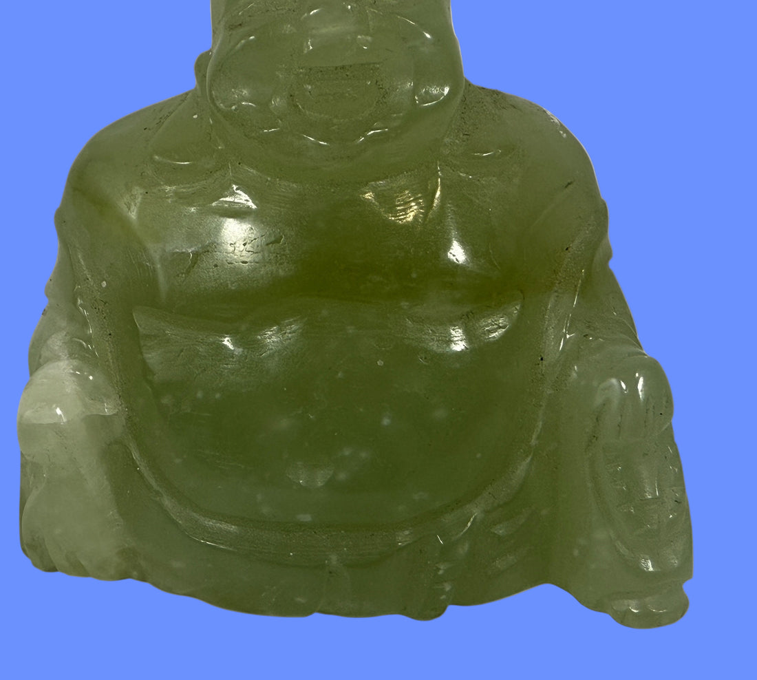 Green jade Buddha statue on a white background