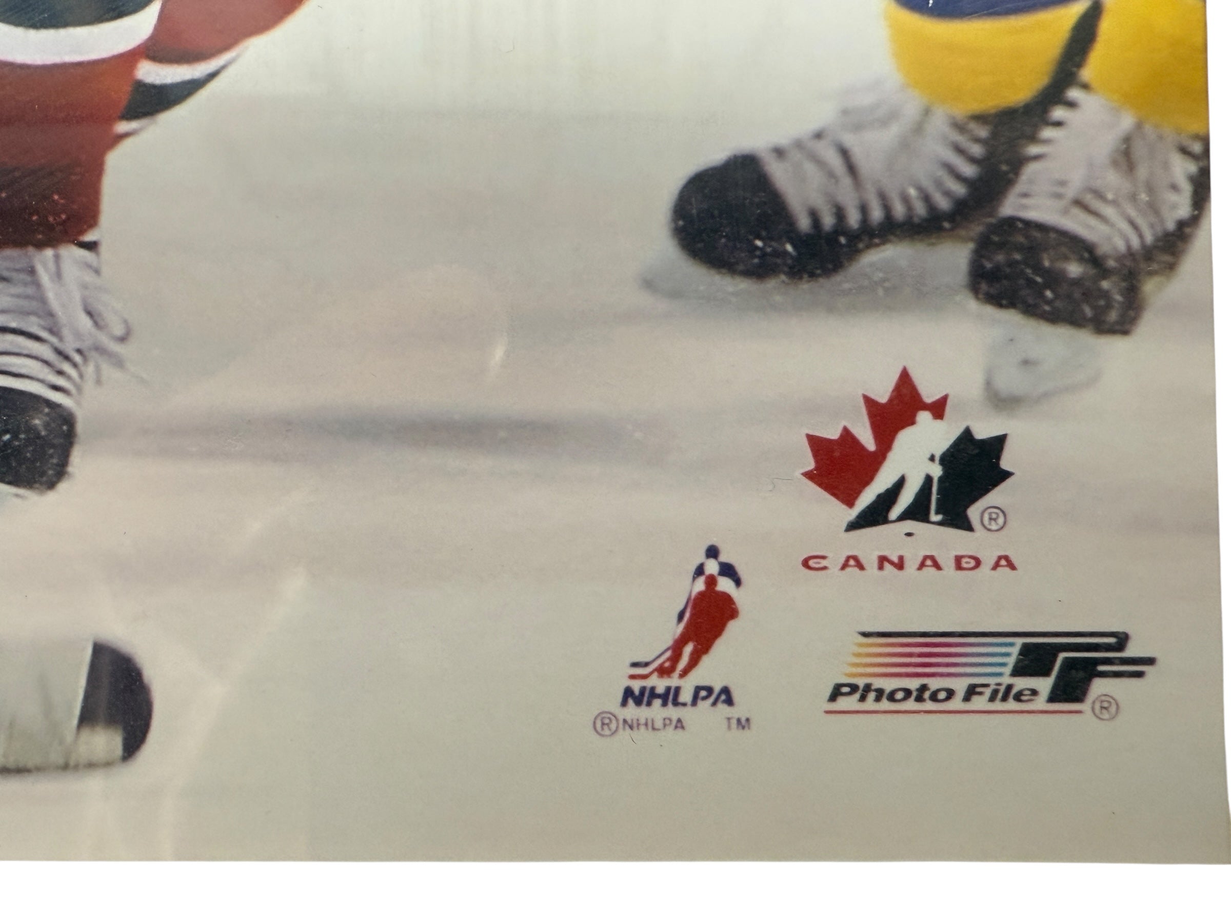 Hockey-themed image with logos of Canada, NHLPA, and Photo File on a white background.