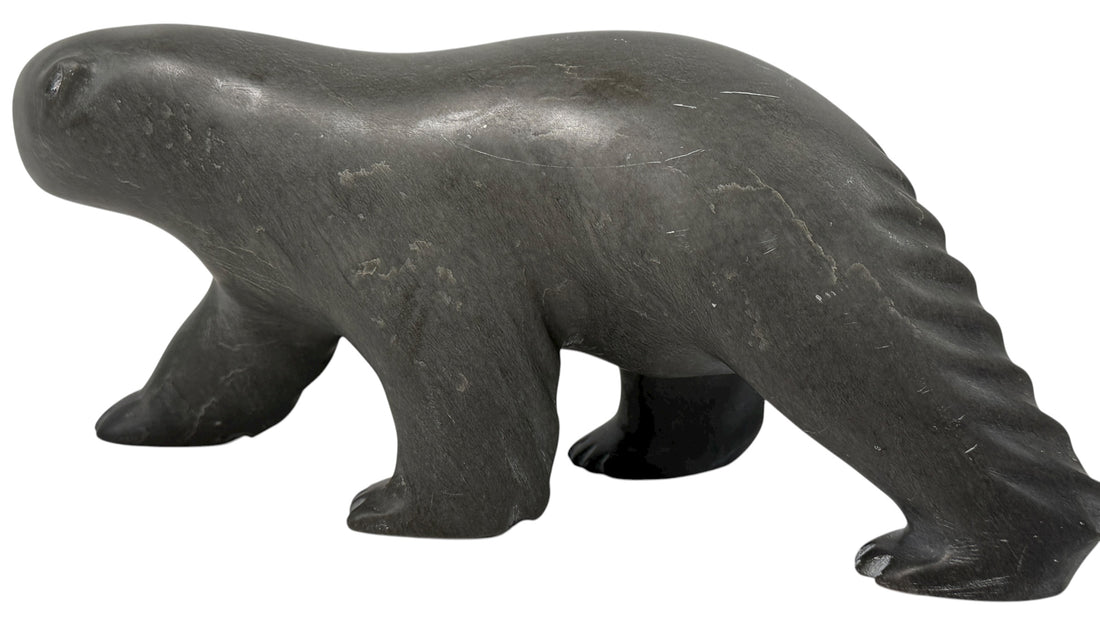 Signed Inuit soapstone bear by Joe Ittukalak (2004) from Nunavik. 10-inch Canadian carving in dark stone—authentic Indigenous art sculpture.