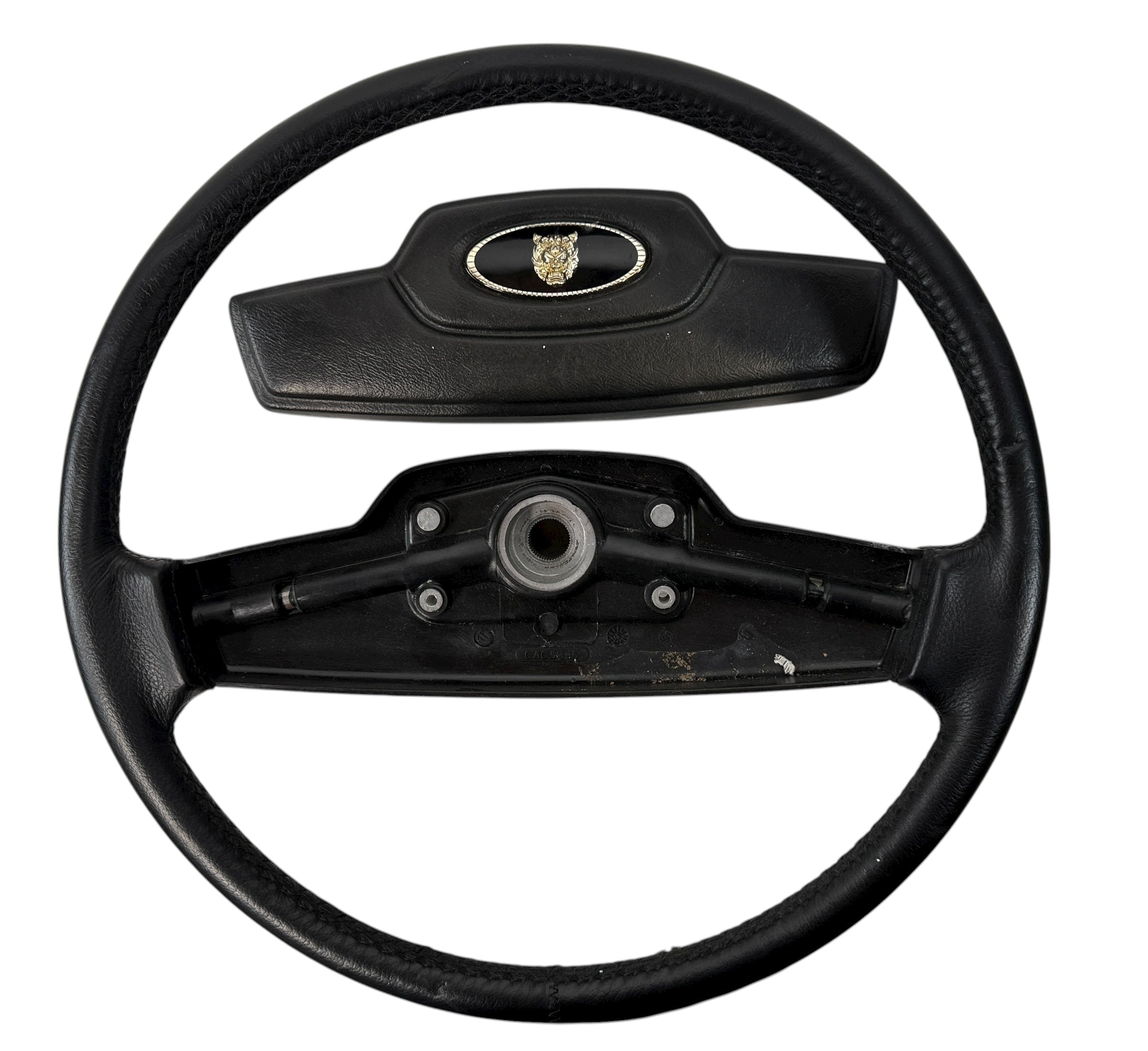 OEM Jaguar XJ6 Series III steering wheel with horn pad. Genuine 1980–87 UK-made replacement part in good driver condition. Vintage Jaguar interior collectible.