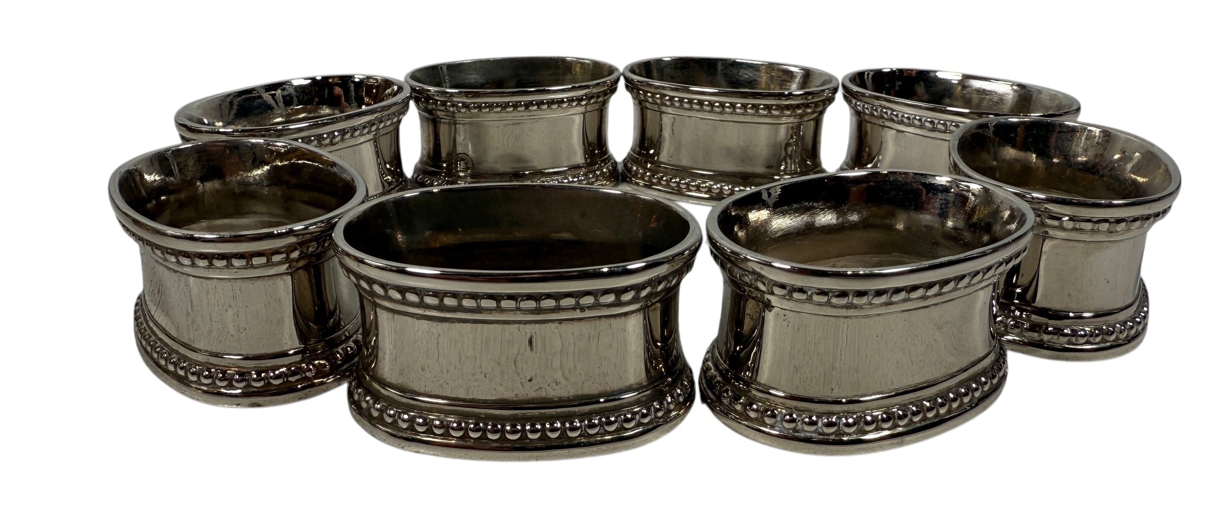 Set of 8 classic silverplate napkin rings with beaded edges. Unmonogrammed, polished, and in very good condition. Timeless tableware.