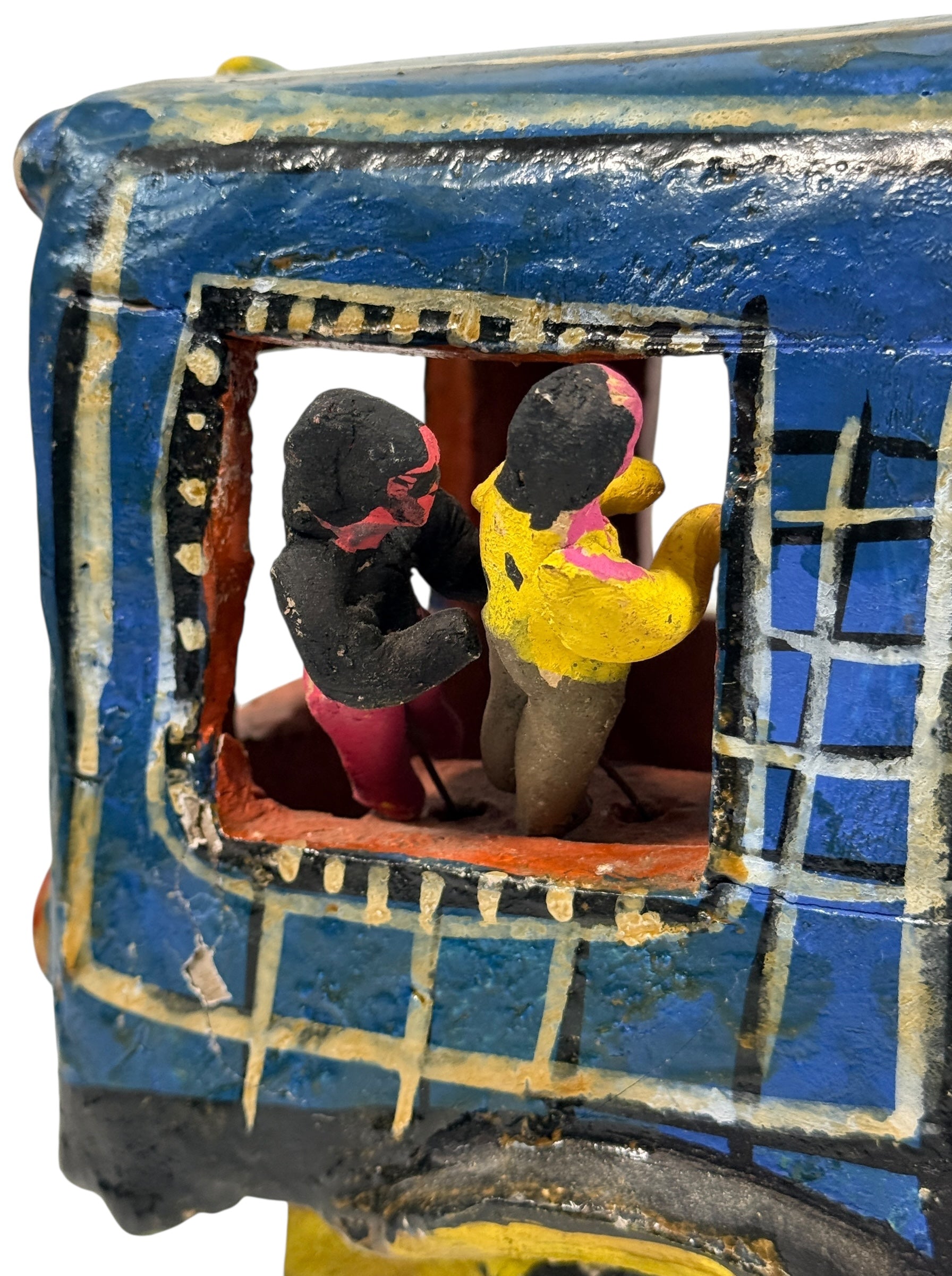 Vintage Mexican papier-mâché colectivo bus sculpture with hand-modeled interior figures. Folk art narrative piece with bold color and strong display presence.