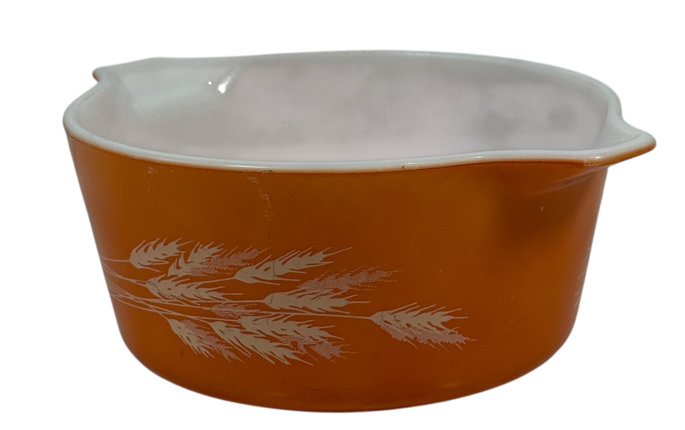 Pyrex, Orange ceramic mixing bowl with white floral design on a white background