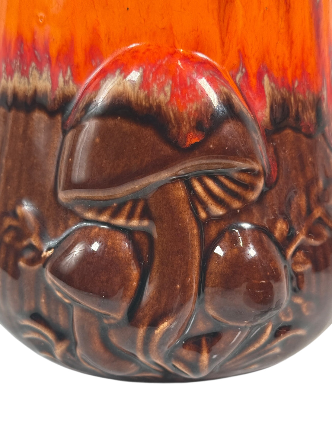 Ceramic jar with a detailed design of a mushroom on a red background