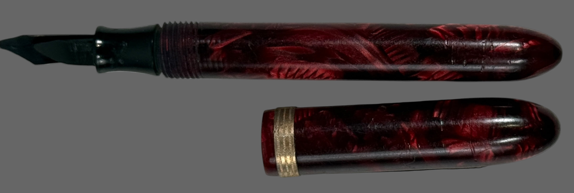 Penco Fountain pen with maroon and black design on a white background