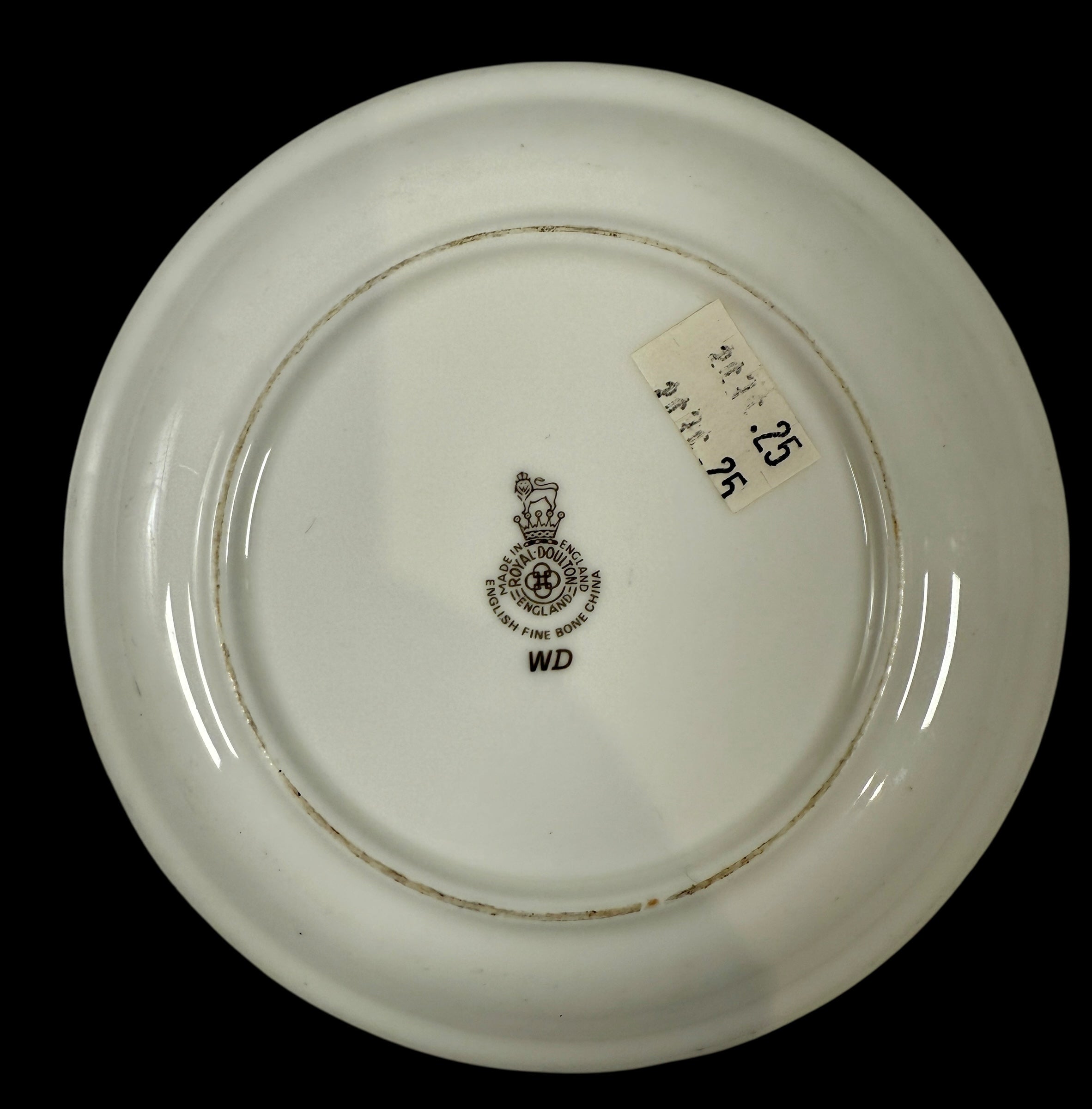 White ceramic plate with a a Royal Doulton Crest  on a black background
