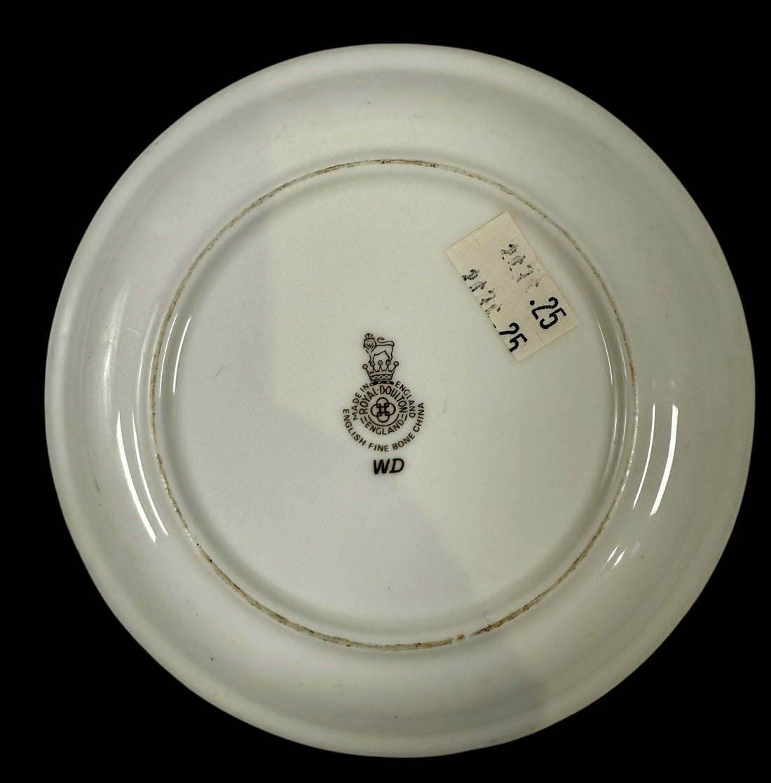 White ceramic plate with a a Royal Doulton Crest  on a black background