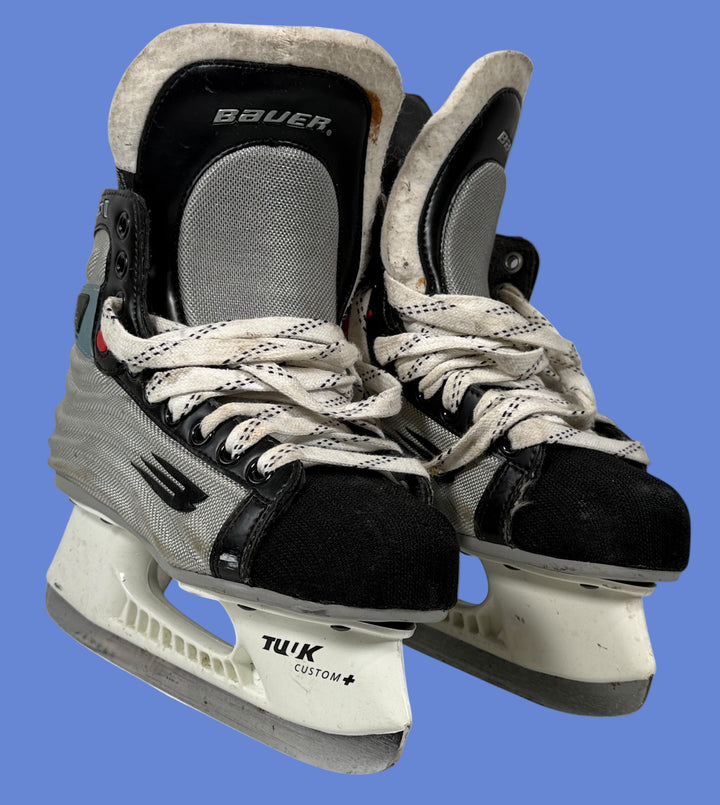 Pair of Bauer ice hockey skates on a white background