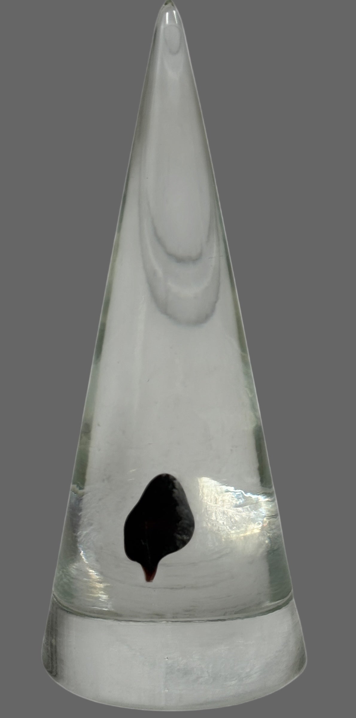 Vintage clear glass cone paperweight with dark red-brown inclusion. Mid-century modern décor collectible, polished base, unsigned art glass accent.
