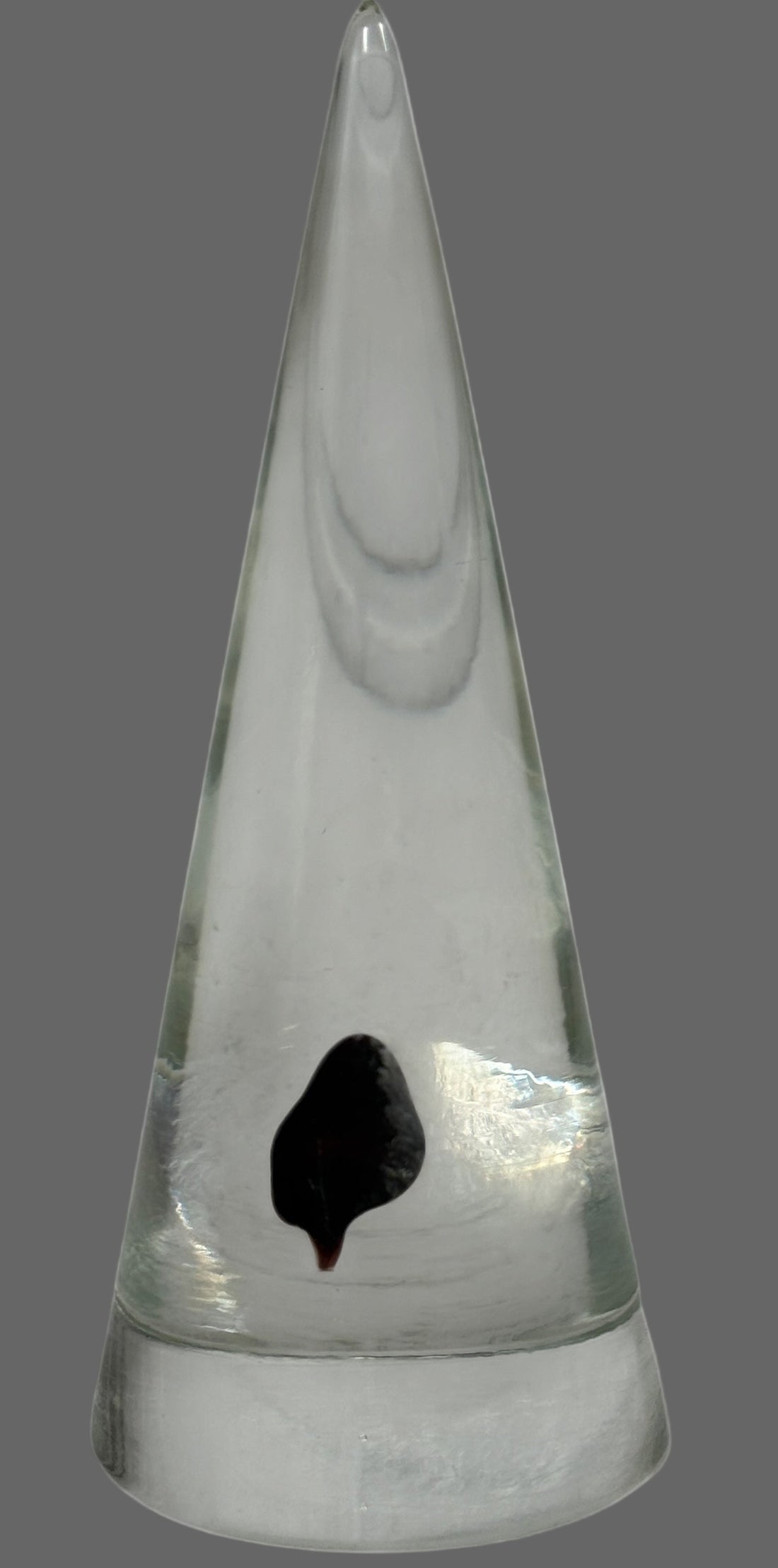 Vintage clear glass cone paperweight with dark red-brown inclusion. Mid-century modern décor collectible, polished base, unsigned art glass accent.
