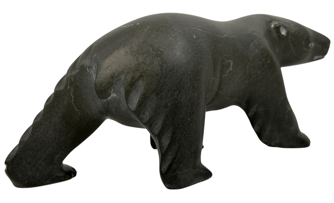 Signed Inuit soapstone bear by Joe Ittukalak (2004) from Nunavik. 10-inch Canadian carving in dark stone—authentic Indigenous art sculpture.