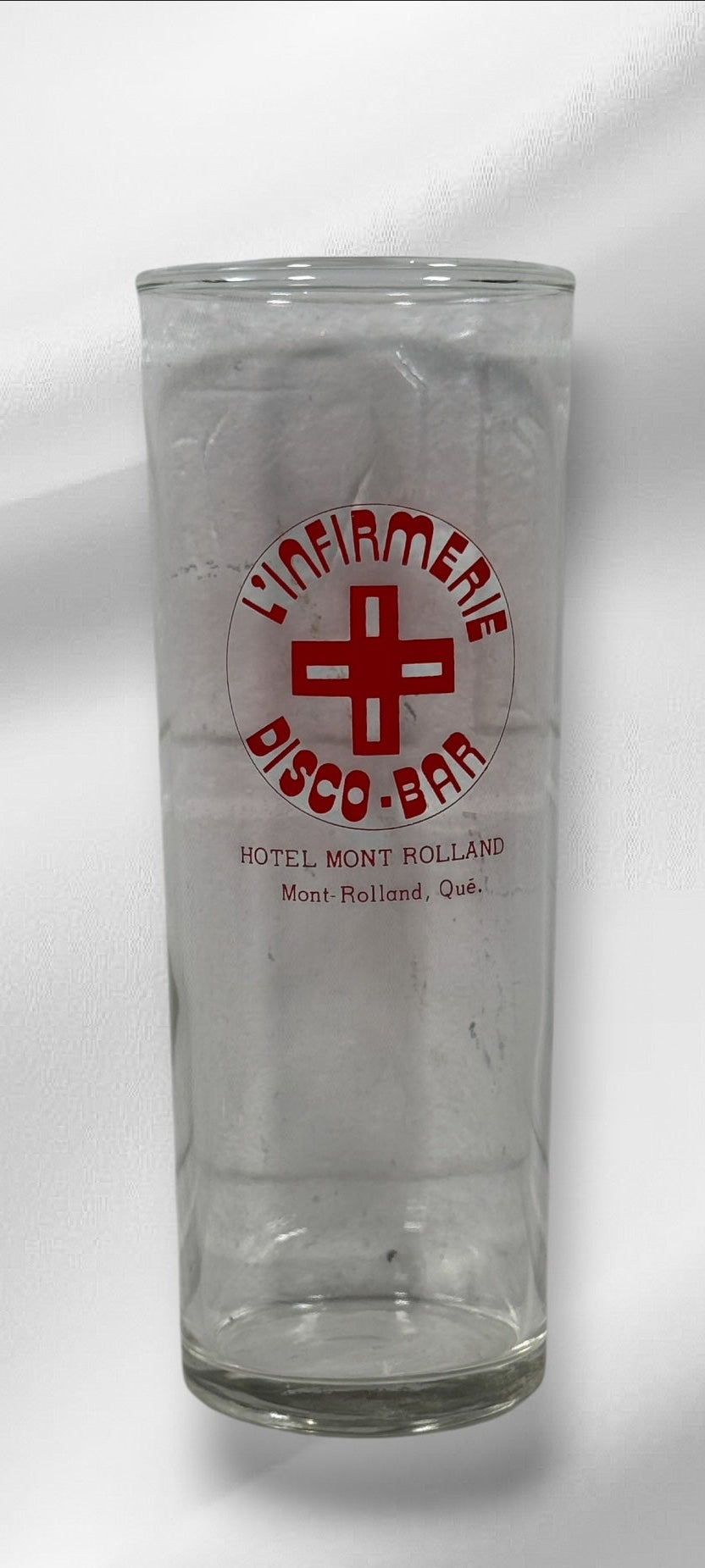 Vintage L’Infirmerie Disco-Bar souvenir glasses from Mont-Rolland, Québec. Rare nightlife memorabilia in excellent condition. Pair of original high-ball glasses.