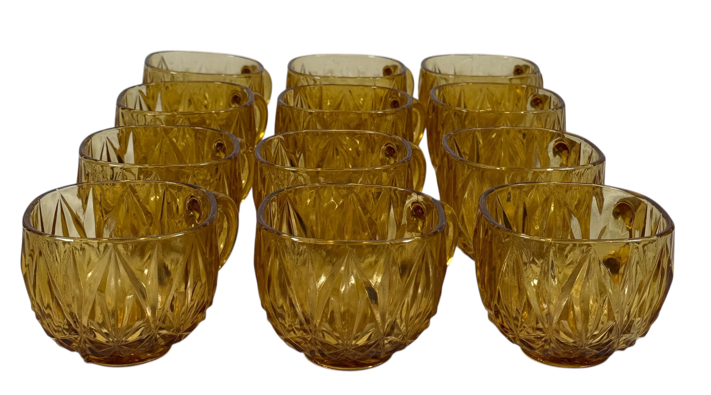 Vintage mid-century amber glass punch bowl set with cups and ladle. Classic starburst pattern, complete set, perfect for retro entertaining.
