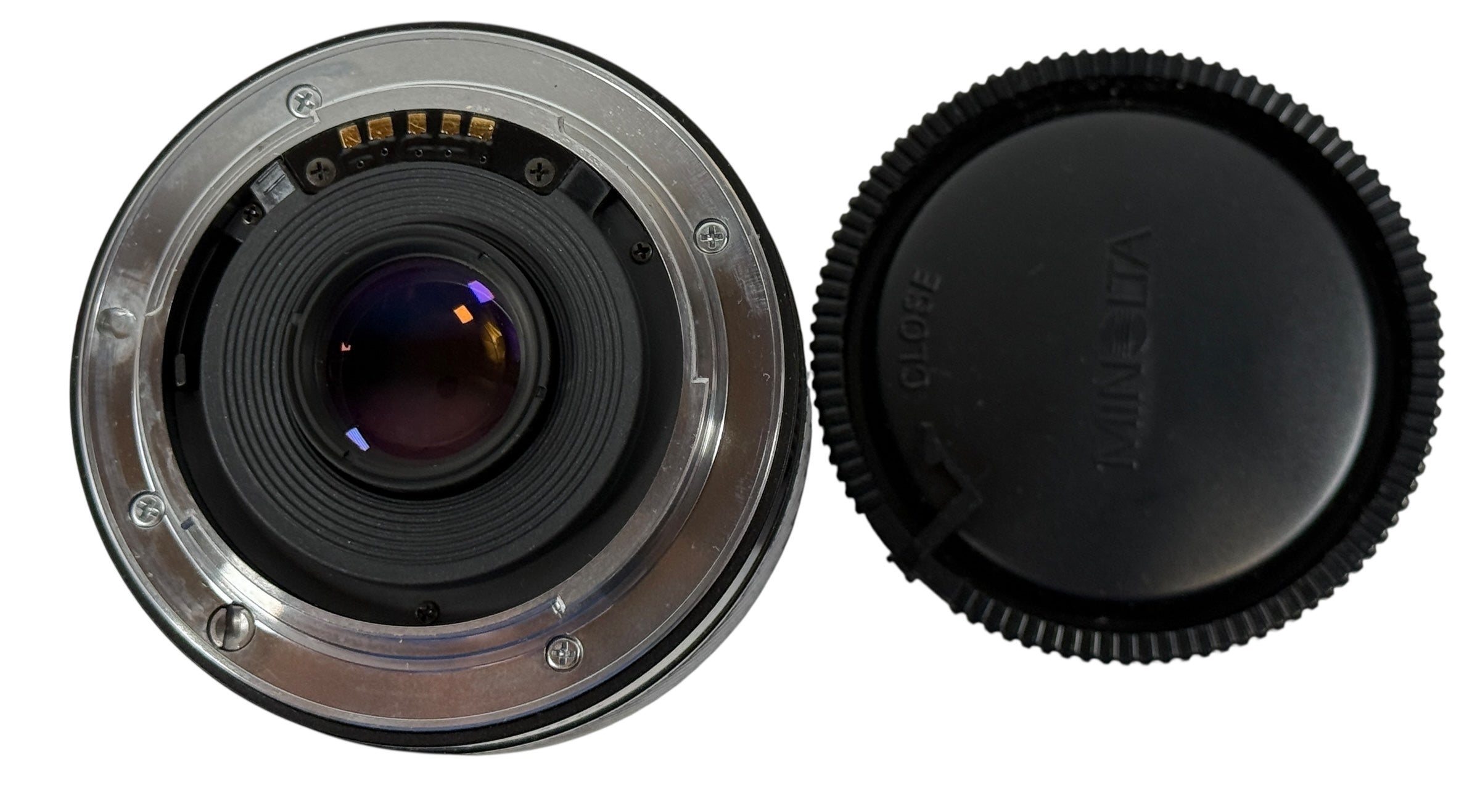 Camera lens with front element and cap on a white background