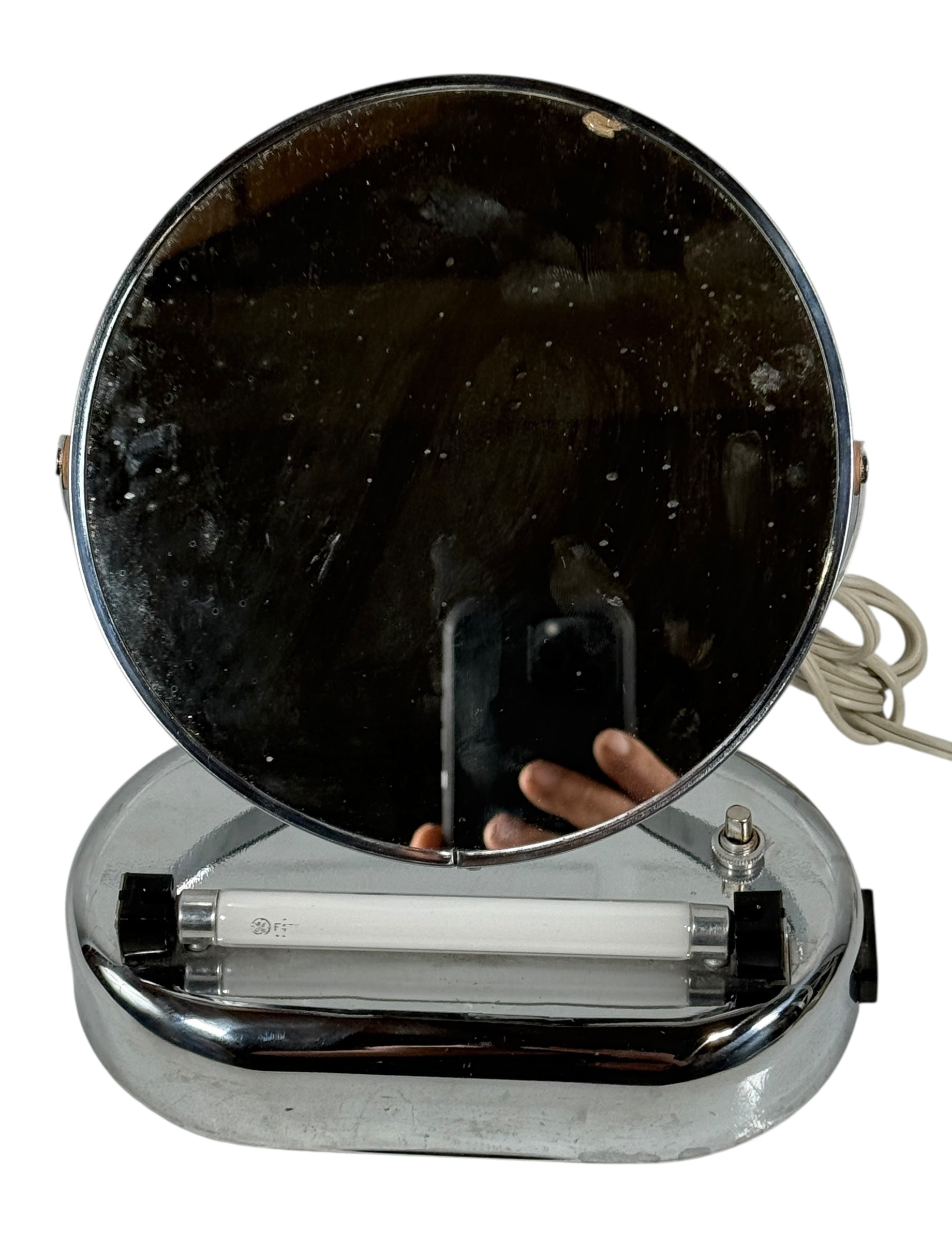Vintage-style makeup mirror with round black glass and chrome base on a white background