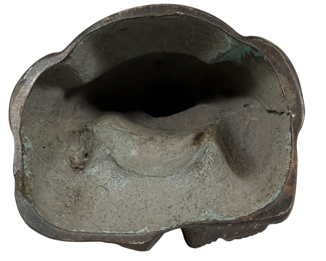 Bronze sculpture of a reclining figure on a white background