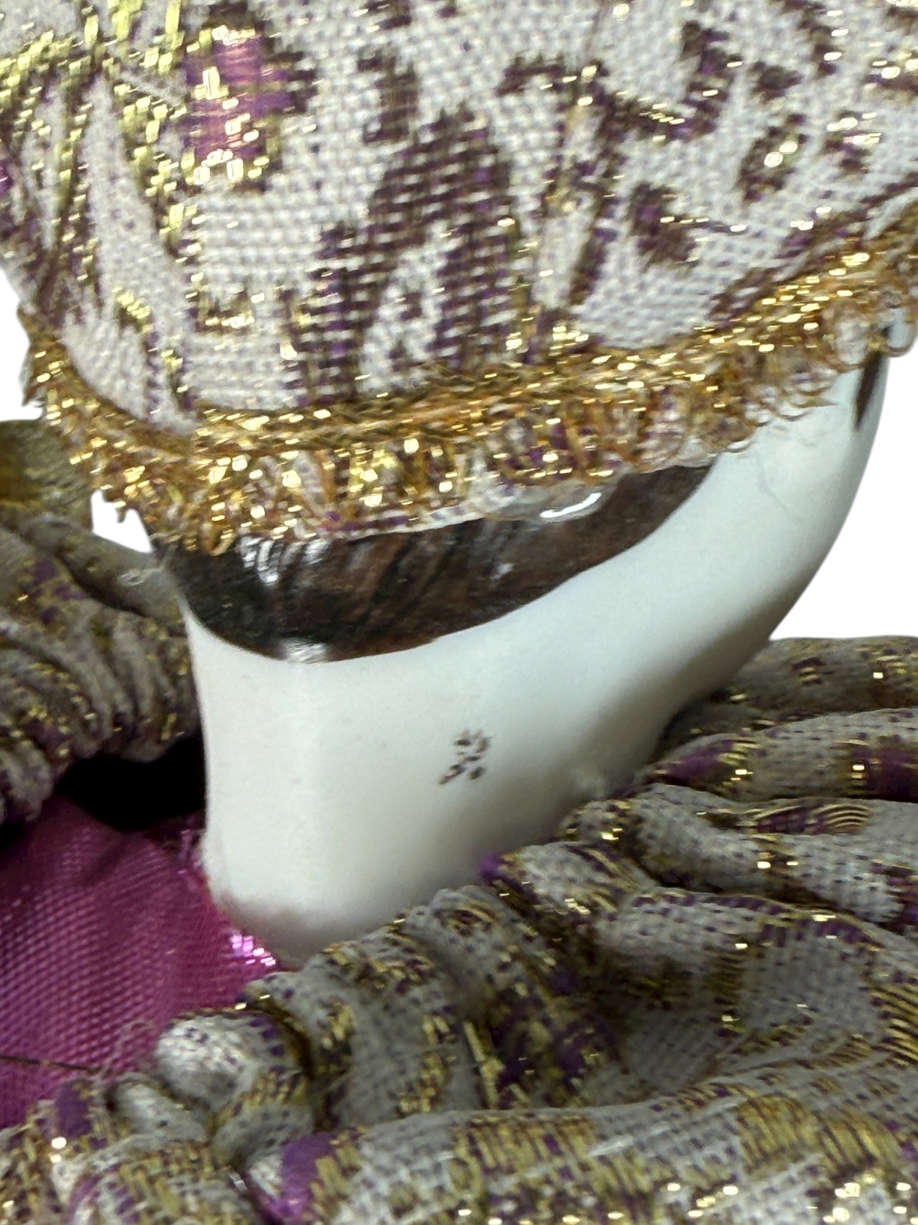 Vintage 18″ porcelain jester doll with mint satin and brocade costume. Elegant décor piece with porcelain head, hands, and feet.
