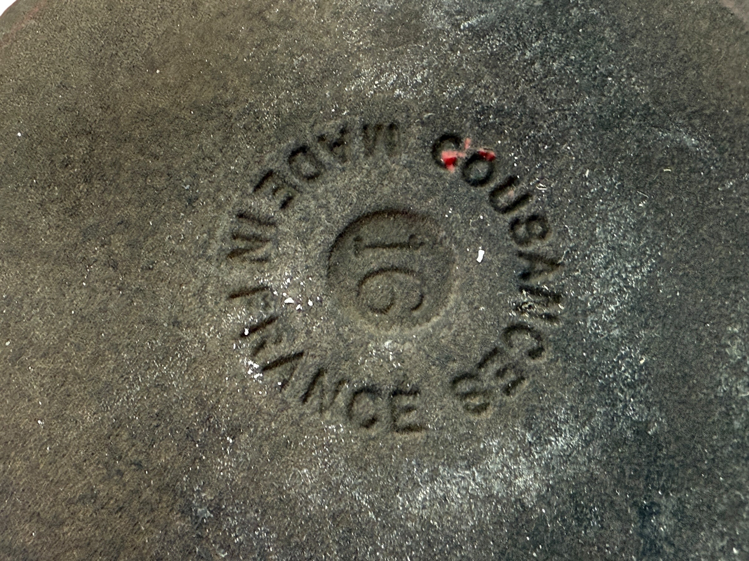Close-up of a cast iron skillet with 'Le Creuset' branding.