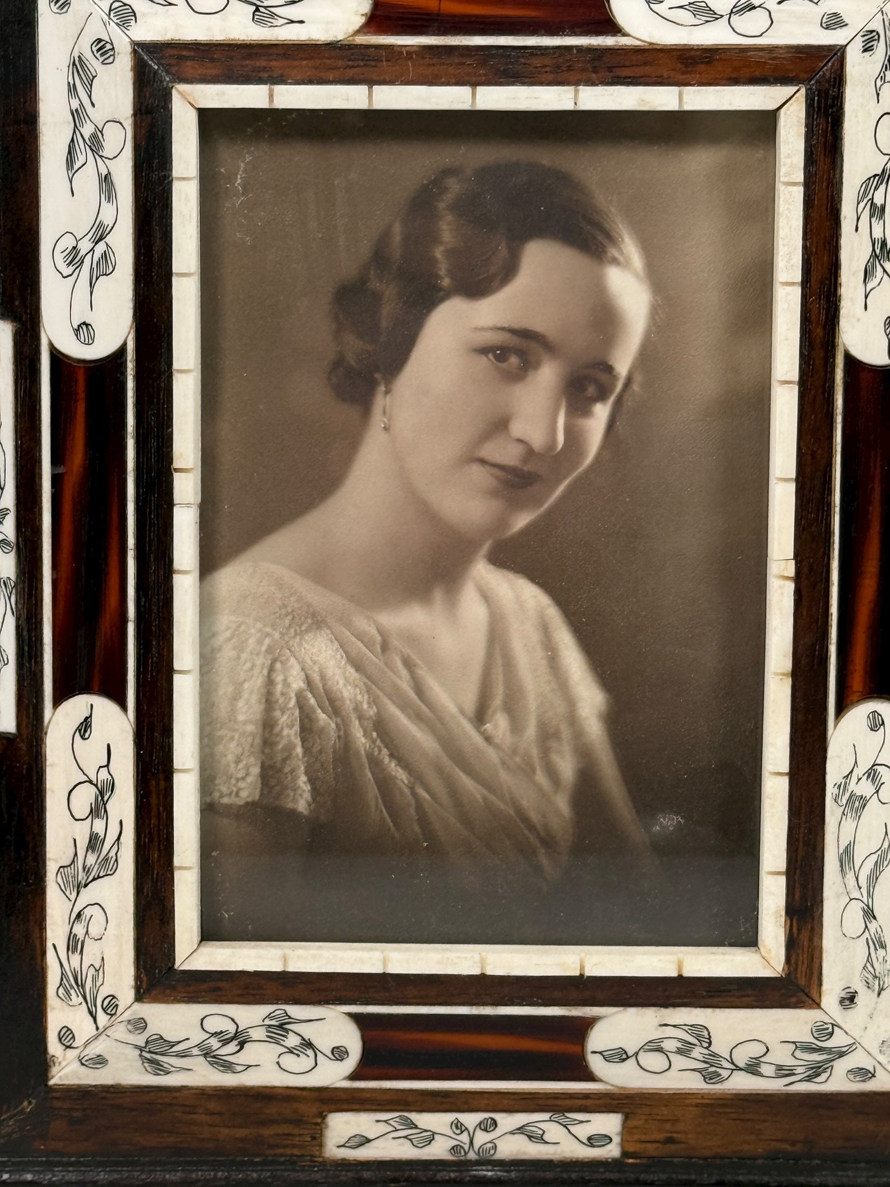 Vintage portrait of a woman in a decorative frame with floral patterns