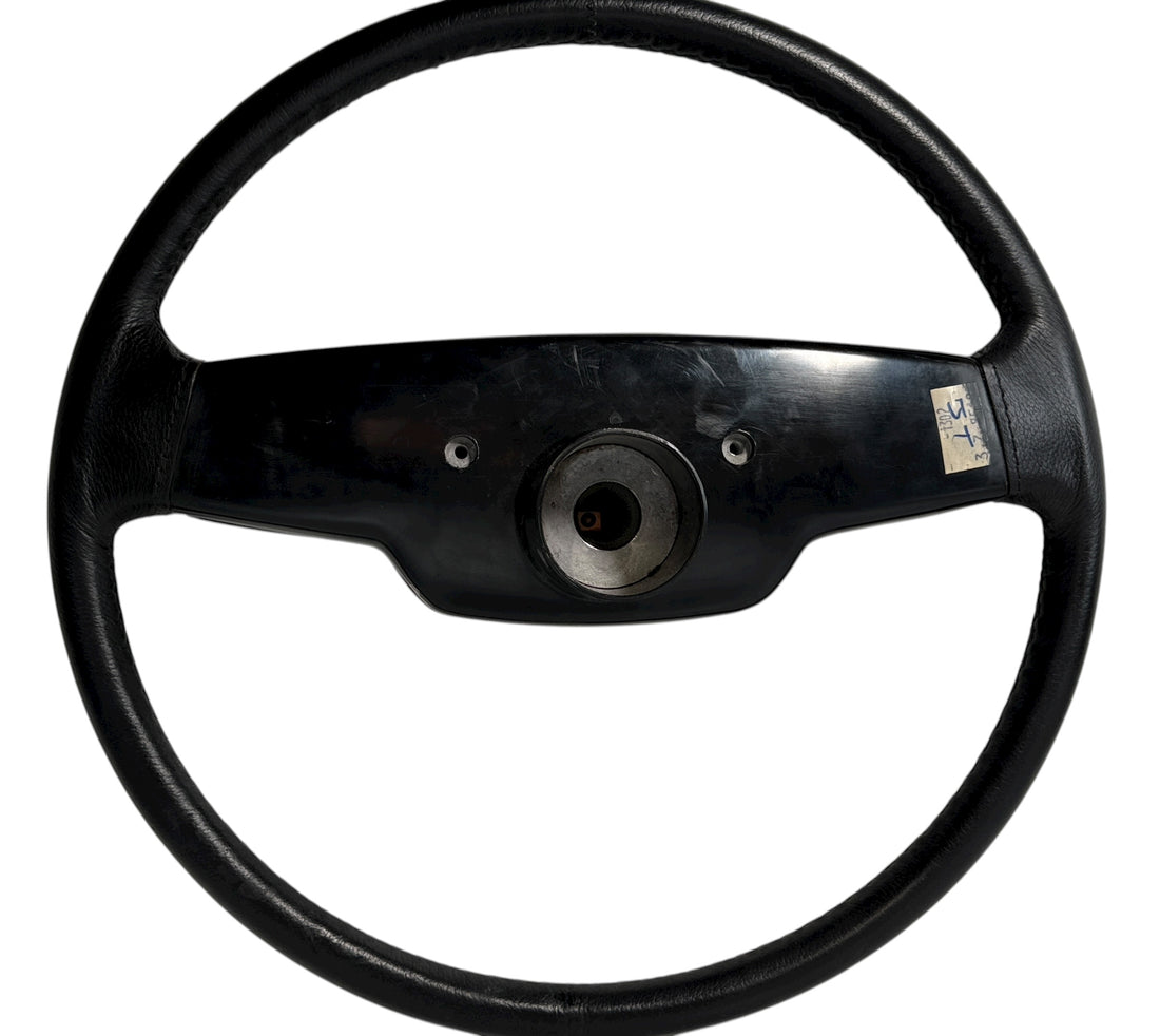OEM Jaguar XJ6 Series III steering wheel with horn pad. Genuine 1980–87 UK-made replacement part in good driver condition. Vintage Jaguar interior collectible.