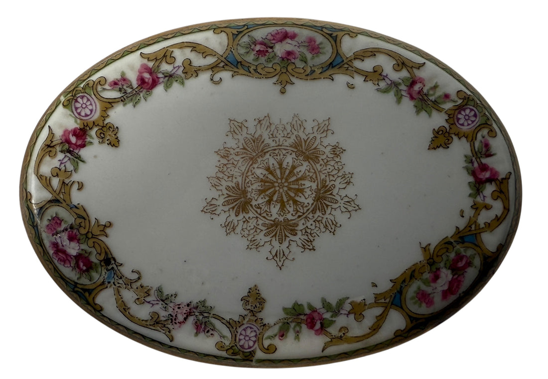 Antique French-style porcelain trinket box with gilt bronze legs, c.1900. Elegant vanity décor with floral details and classic Belle Époque charm.