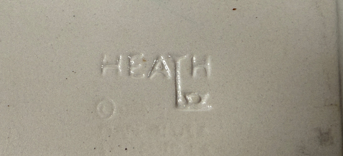Text 'HEATH' embossed on a textured surface