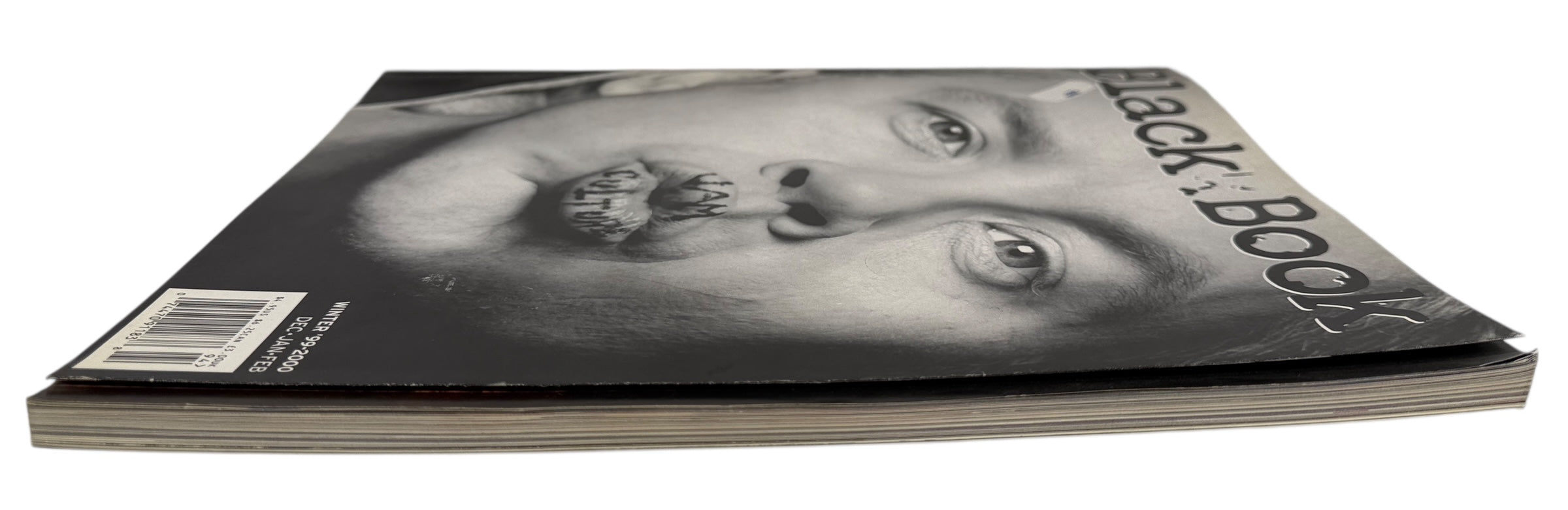 Magazine with a black and white cover featuring a face design on a white background