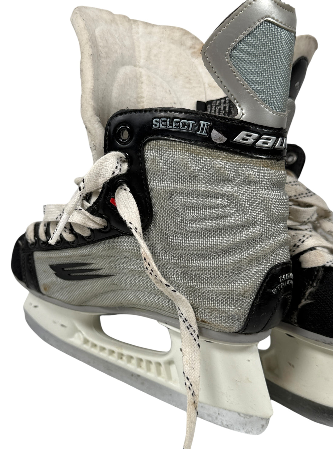 Pair of gray ice hockey skates with white laces on a white background