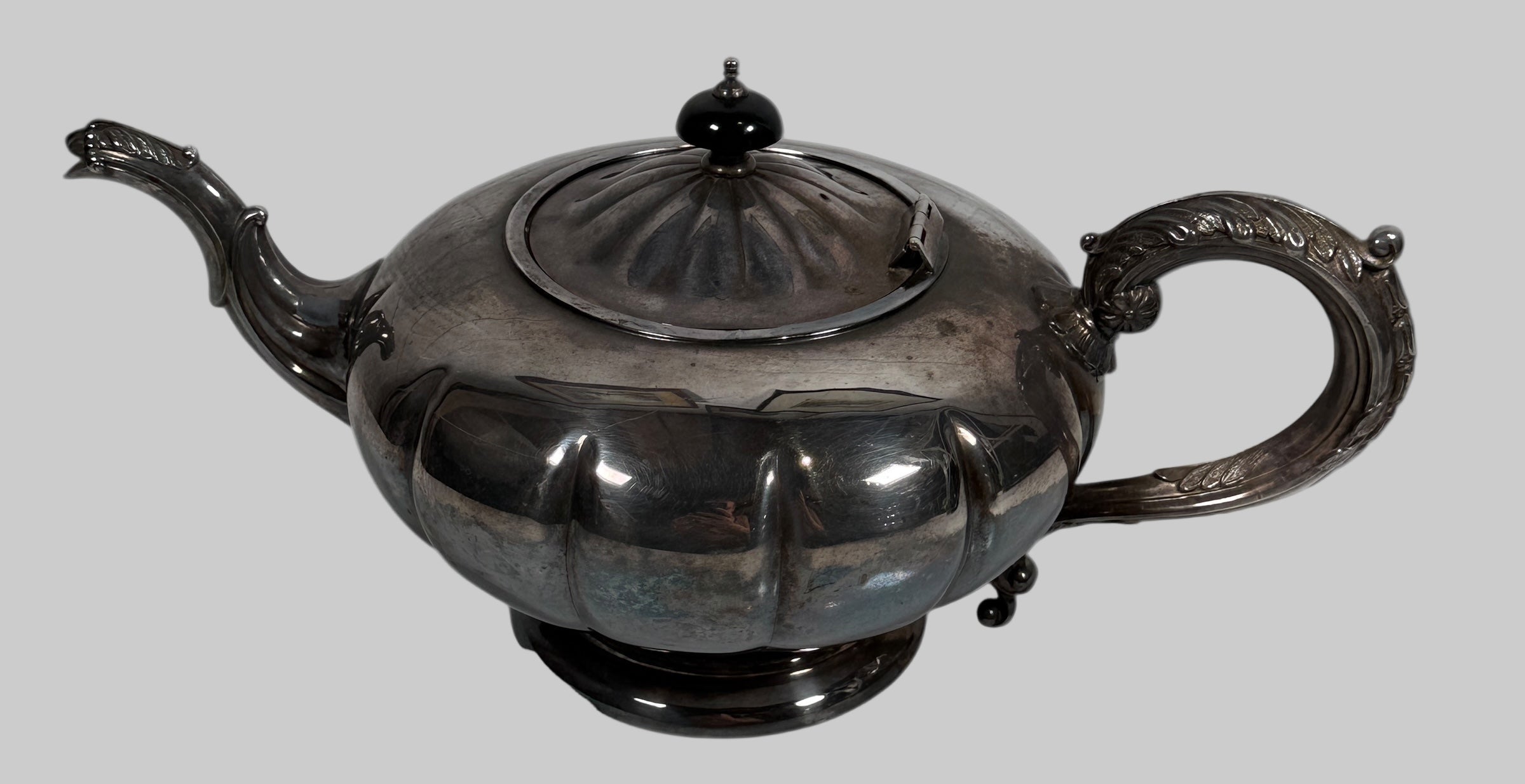 Decorative silver teapot on a white background