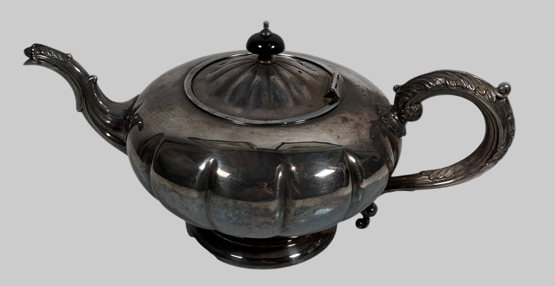 Decorative silver teapot on a white background