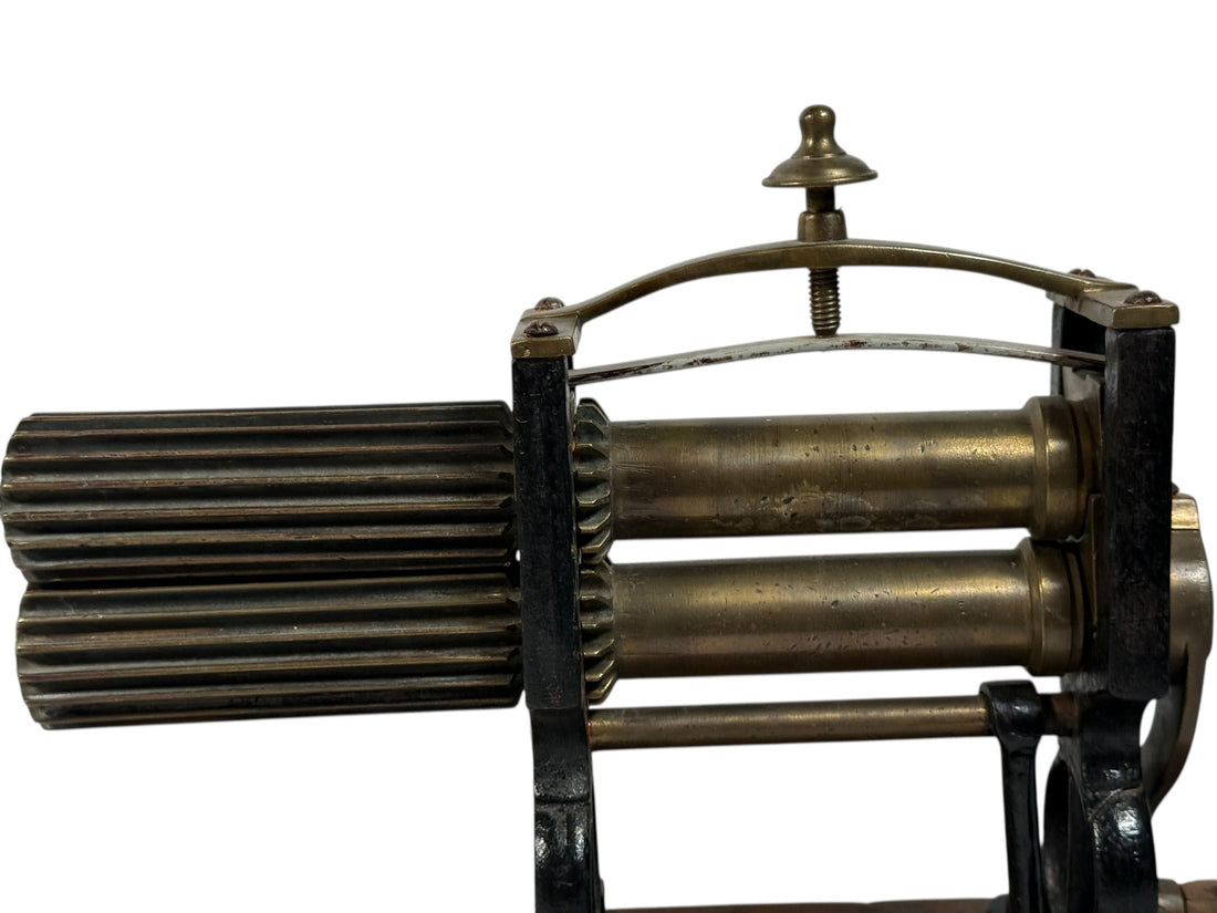 Vintage metal machine with cylindrical components on a white background