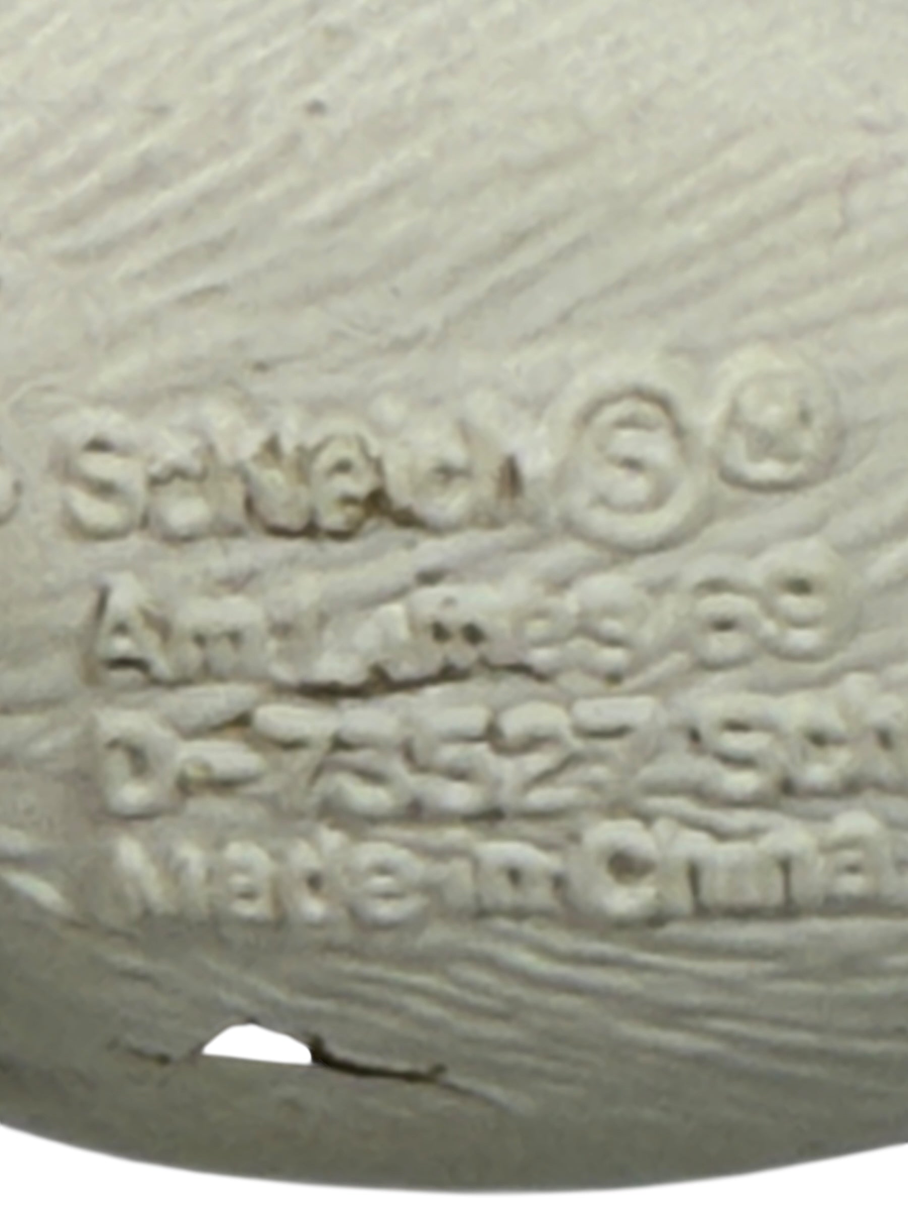 Close-up of a textured surface with embossed text, including 'Made in China'.