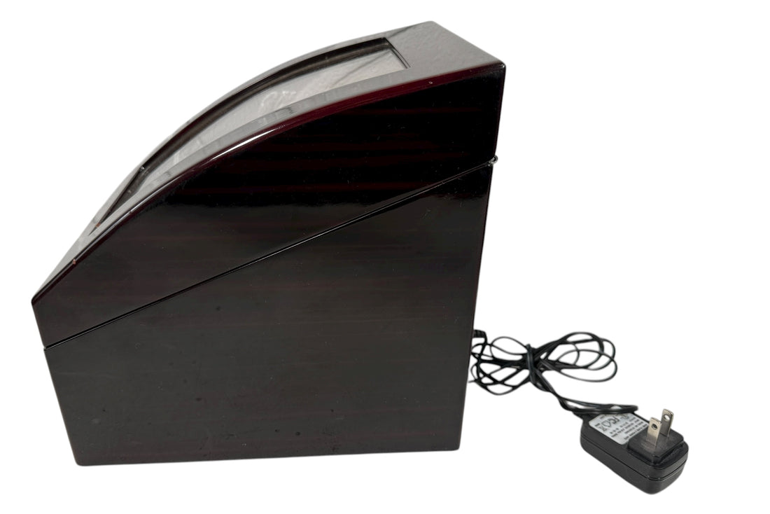 Working dual automatic watch winder in piano black lacquer with storage, display lid, and AC adaptor. Clean, functional, and perfect for protecting your watches.