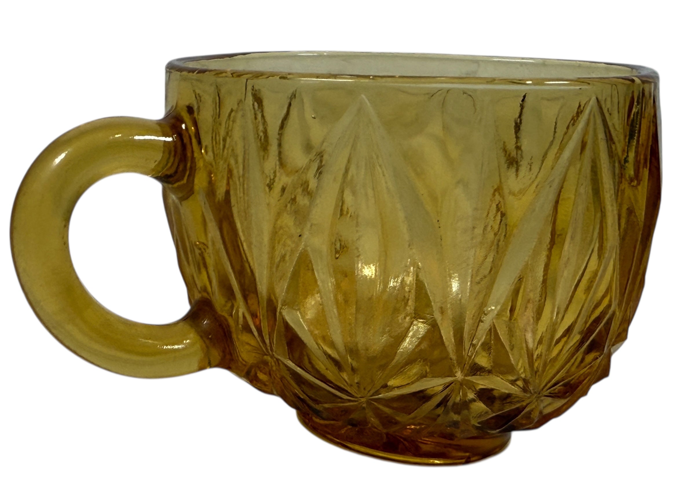 Vintage mid-century amber glass punch bowl set with cups and ladle. Classic starburst pattern, complete set, perfect for retro entertaining.