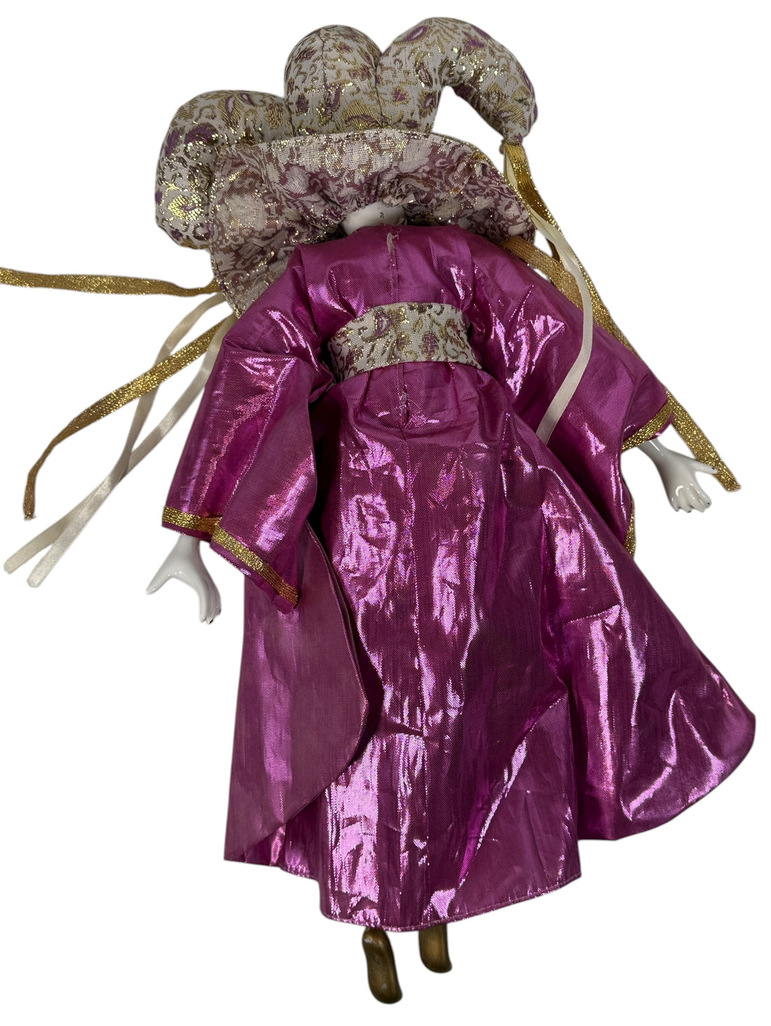 Traditional doll in a pink outfit with decorative headpiece on a white background
