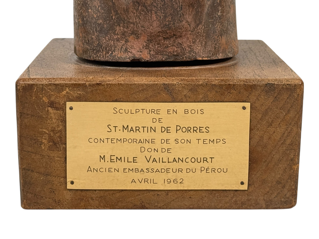 Bronze sculpture base with a gold plaque on a white background